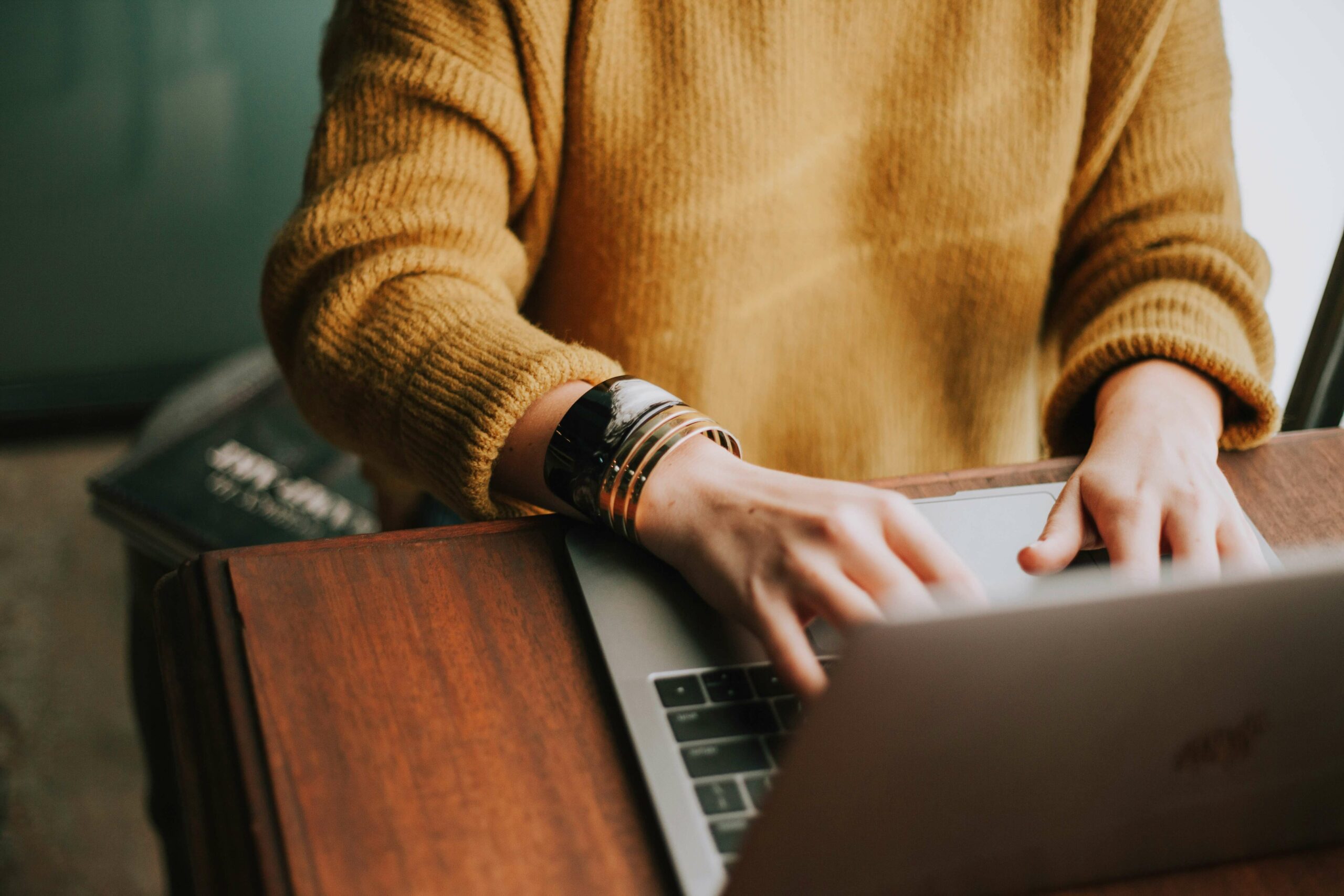 woman typing on laptop using long tail keywords for writing an article